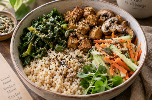 Vegetarian Buddha bowl with brown rice, cooked soy chunks, sautéed mushrooms, leafy greens, carrot and cucumber salad, and mixed seeds.